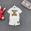  グッチGUCCI の可愛い子供用セットです。白い T シャツには大きな「GUCCI」のロゴとモノグラム柄のテディベアがデザインされ、個性的で注目を集めます子供用のサマースーツ,男の子と女の子です
